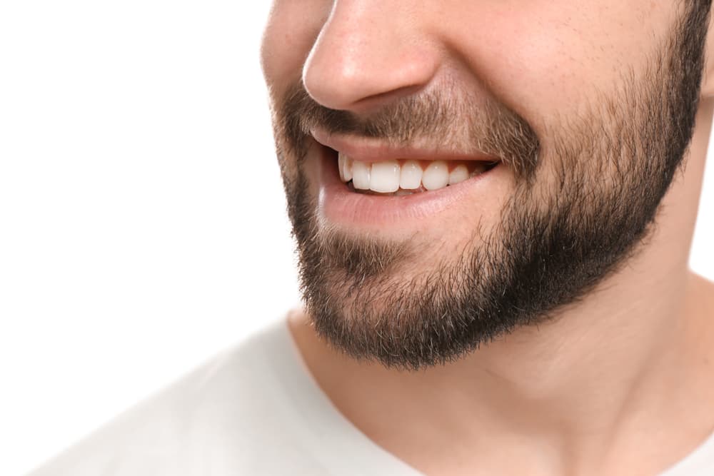 Close-up of a man with a healthy, natural smile