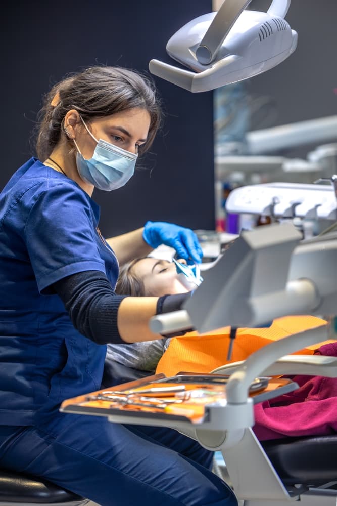 A dental professional carrying out treatment in the clinic