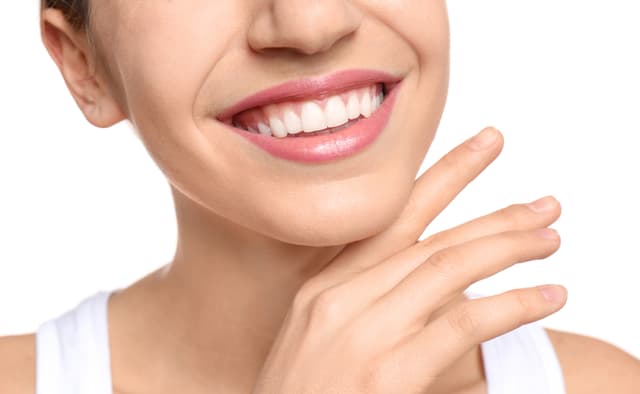 A woman with a confident, healthy smile