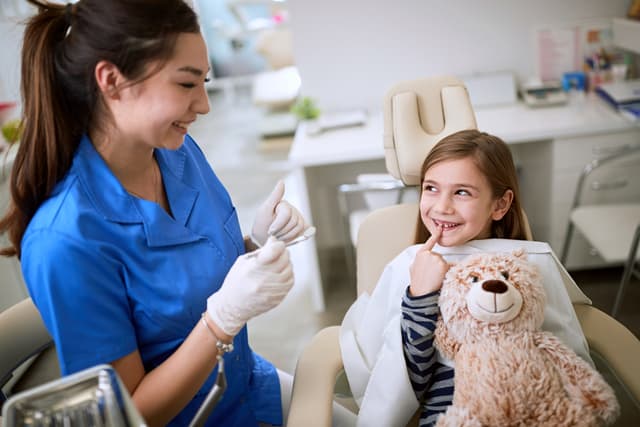 A friendly dentist treating a young child at a check-up