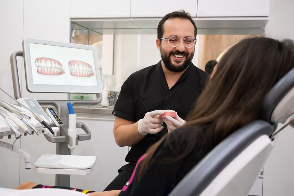 A dentist explaining a treatment plan to a patient in the clinic